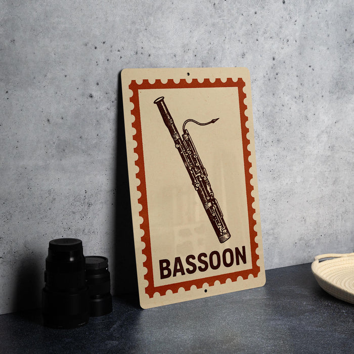 A metal sign with a picture of a bassoon on it, placed on a table next to some black camera lenses.