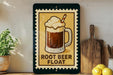 A framed illustration of a root beer float on a shelf, with a wooden cutting board and a potted plant nearby.