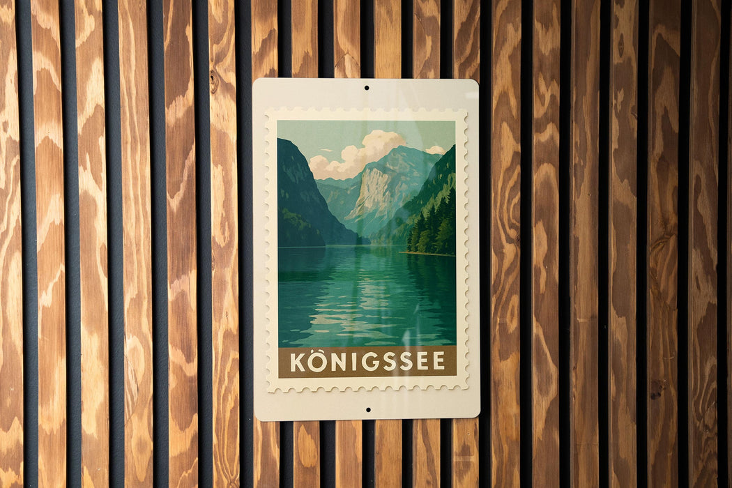 A framed poster of a mountain landscape with a lake is displayed on a wooden wall.