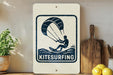 A sign that reads "Kitesurfing" is displayed on a shelf next to a potted plant and a wooden cutting board.