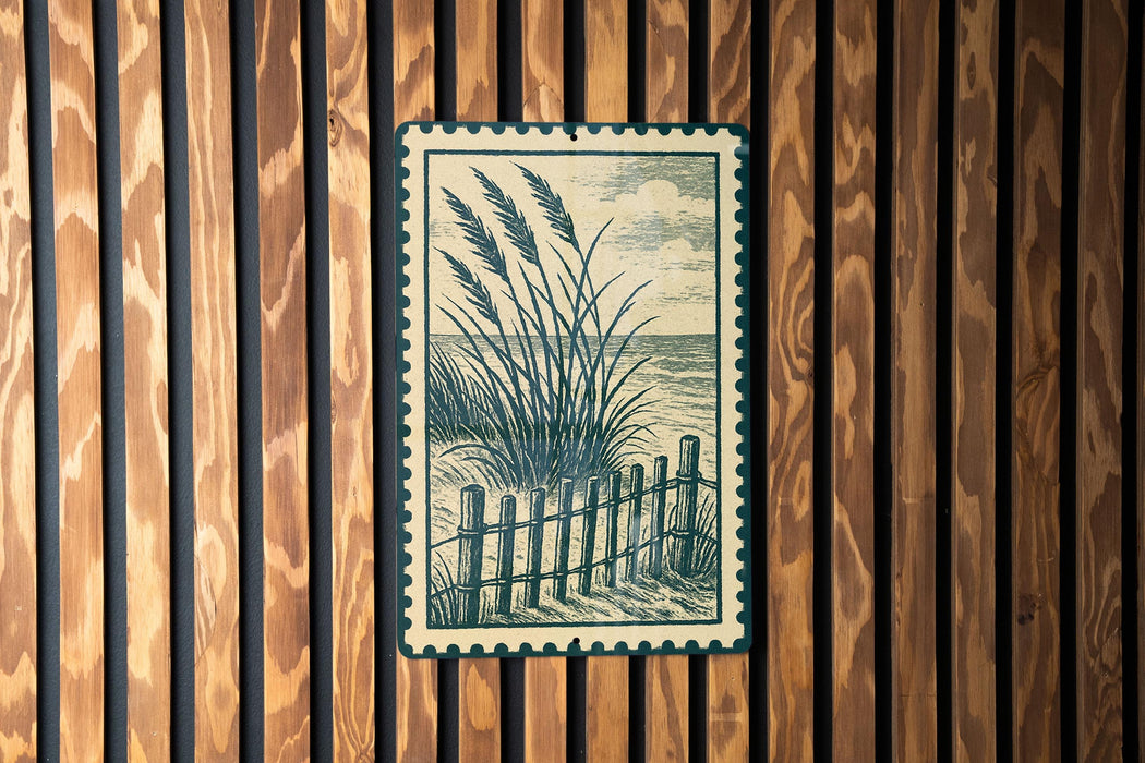 A framed illustration of tall grasses and a wooden fence is displayed on a wooden wall.