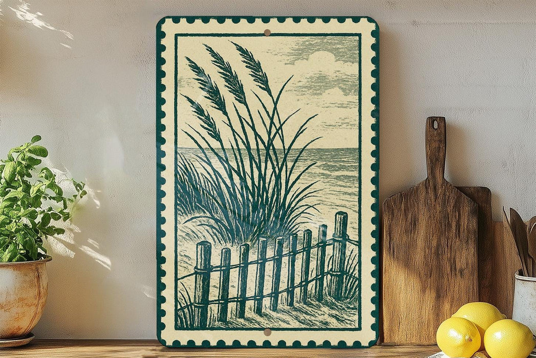 a framed artwork depicting a beach scene with a wooden fence and grassy plants, placed on a shelf next to a cutting board and a potted plant.