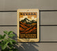 A vintage-style sign for Nevada High Country Overlooks, featuring a mountain landscape with clouds and text that reads "NEVADA HIGH COUNTRY OVERLOOKS".