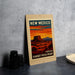 A framed poster of the Sunset Vista Point in New Mexico, featuring a desert landscape with mountains in the background.