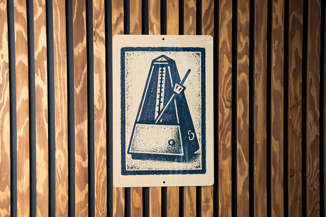 a close-up view of a sign with a stylized illustration of a metronome, which is a musical instrument used to measure time.