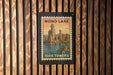 A vintage-style postage stamp depicting the Mono Lake Tufa Towers, with a wooden background.