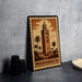 A metal stamp depicting the Marrakech Tower, a famous landmark in Morocco, is displayed on a table.