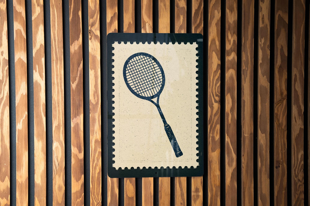 A tennis racket is depicted on a wooden wall, framed within a decorative border.