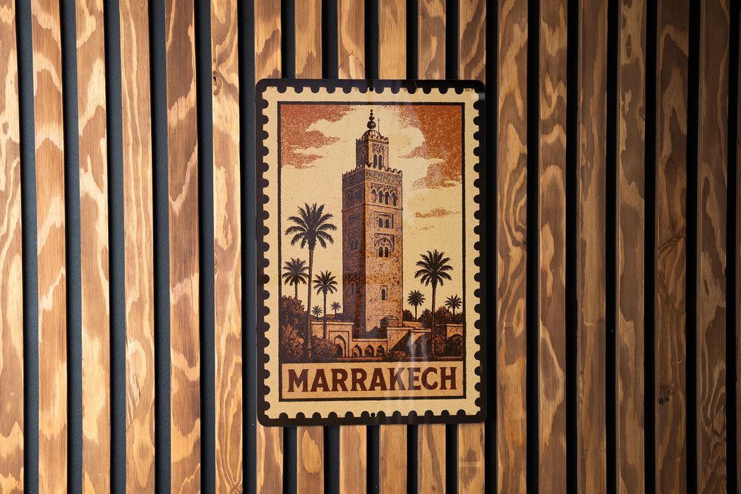 A framed image of a tower with palm trees, mounted on a wooden wall.