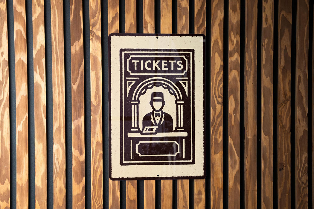 A sign with the word "TICKETS" on it is mounted on a wooden wall.