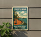 A vintage-style sign for the Louisiana Harborfront Esplanade, featuring a scenic illustration of a park with a walkway, lampposts, and a boat on the water.