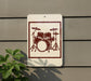 A sign with a drum set illustration is mounted on a wall, with a plant visible to the left.