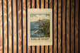 A framed image of the Ring of Kerry, a famous coastal region in Ireland, is displayed on a wooden wall.