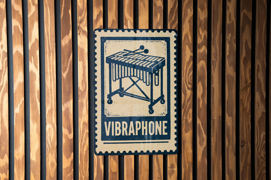A metal sign with a graphic of a musical instrument, specifically a vibraphone, mounted on a wooden wall.