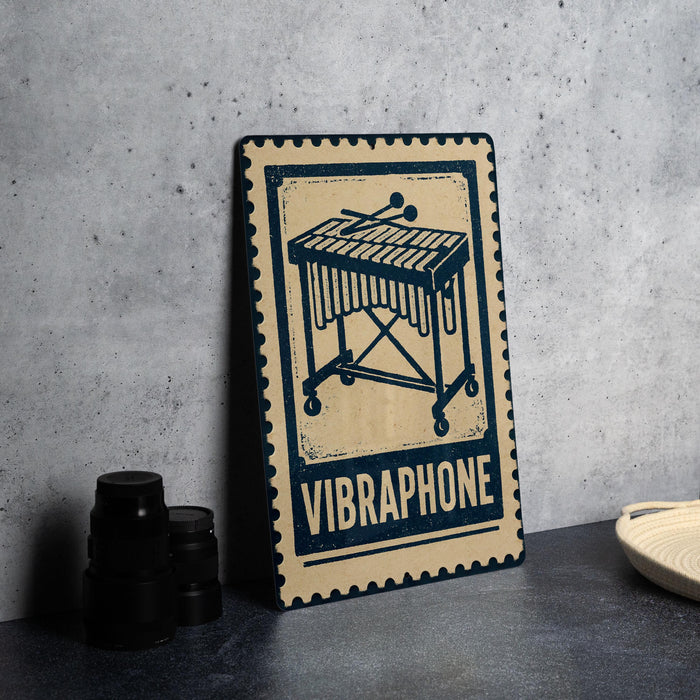 a Vibrophone, a musical instrument, with a stamp-like design on a wooden surface.