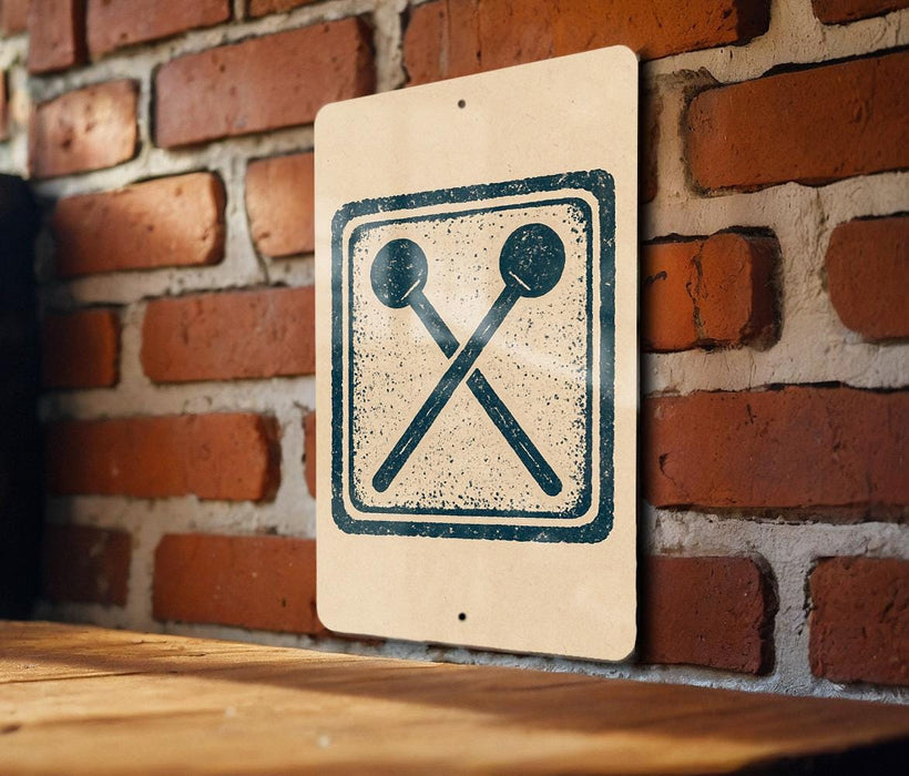 a sign with a symbol of a hammer and a nail on a brick wall.