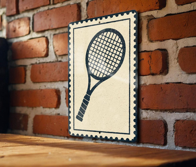 A black and white tennis racket is mounted on a brick wall, with a wooden table below it.