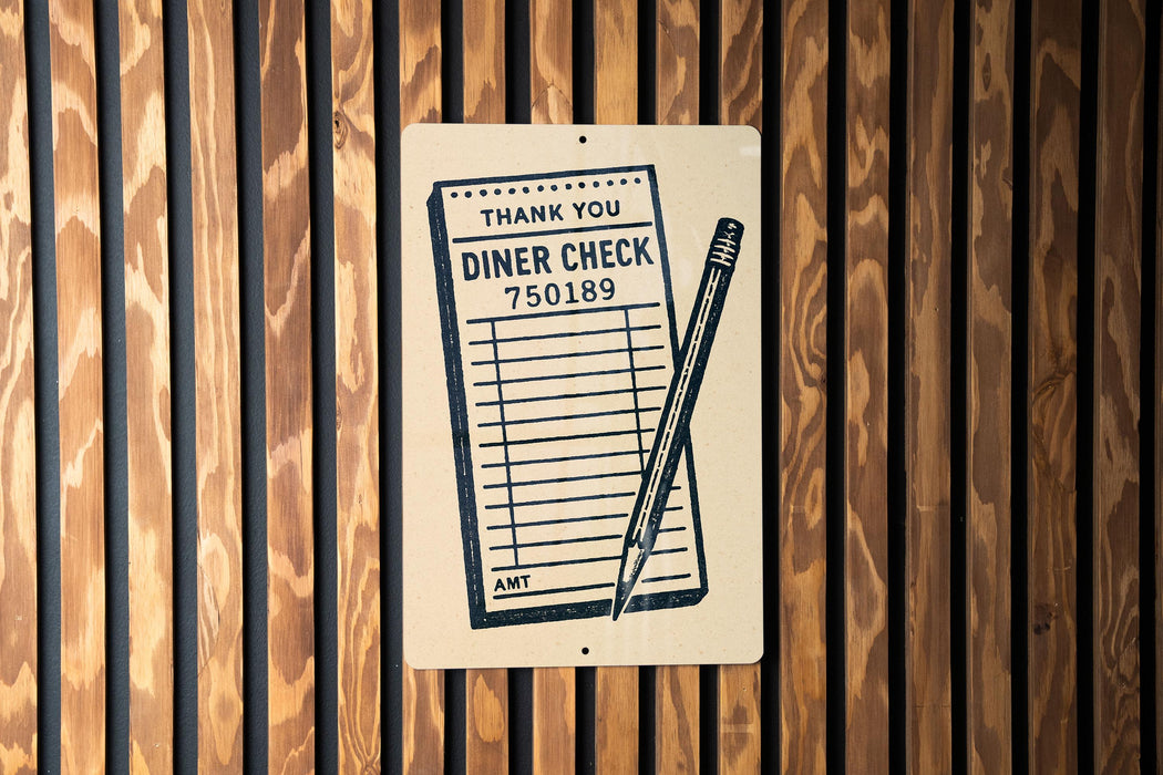 A sign on a wooden wall that reads "THANK YOU DINER CHECK 750189" with a pencil icon.