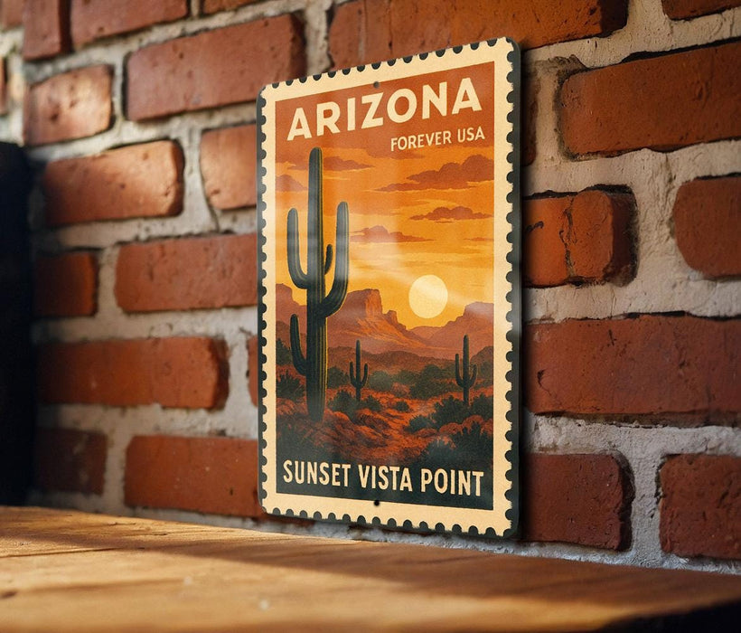 A vintage-style postage stamp depicting a desert landscape with a cactus and mountains, hanging on a brick wall.