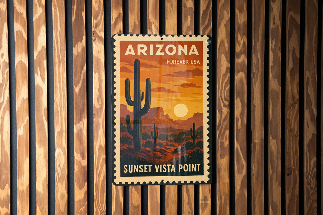 A vintage Arizona Forever USA postage stamp is displayed on a wooden wall, featuring a desert landscape with a cactus and a sunset.