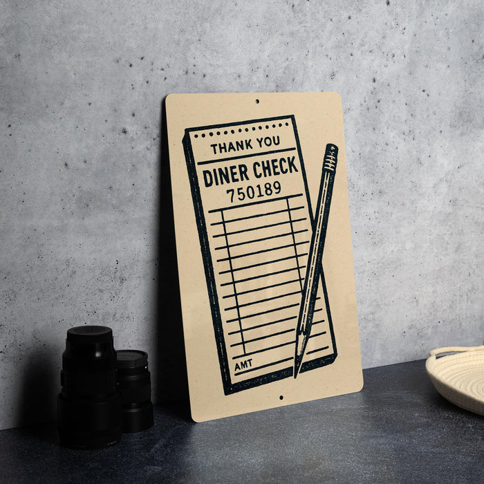 a sign with a list of items and a pencil, placed on a table next to some black camera lenses.