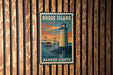 A vintage-style metal sign with the text "RHODE ISLAND" and a lighthouse illustration, mounted on a wooden wall.