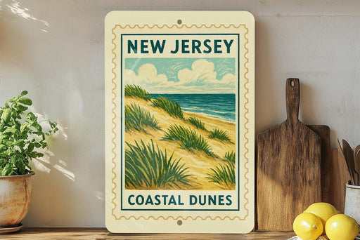A framed poster of a coastal dune landscape hangs on a wall, with a wooden cutting board and a potted plant to the side.