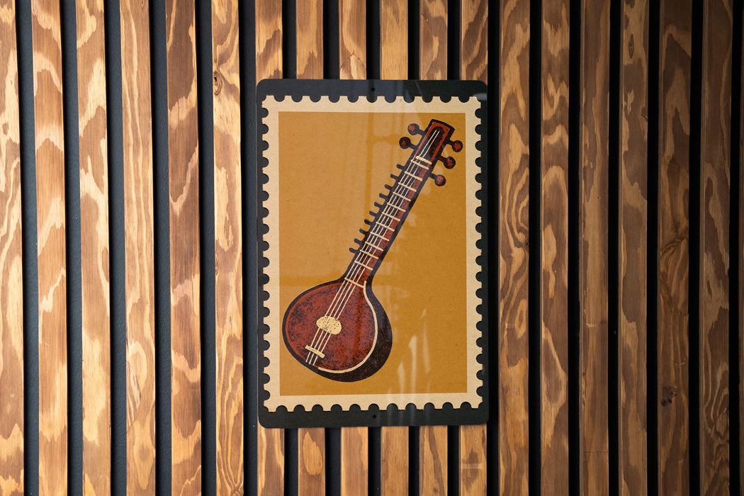a close-up of a musical instrument, possibly a stringed instrument, displayed on a wooden wall.