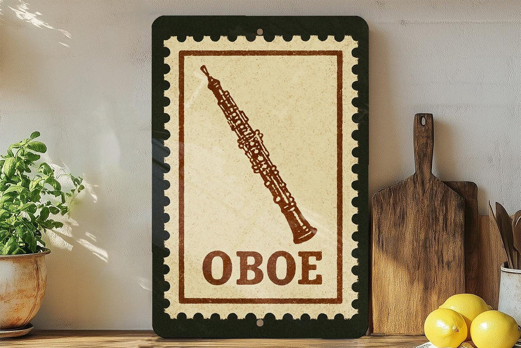 a framed stamp-like sign with the word "OBOE" on it, placed on a wooden surface next to a potted plant and a wooden cutting board.
