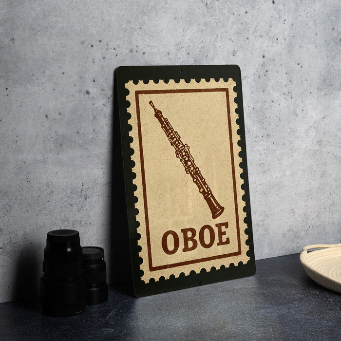 a stamp-like sign with the word "OBOE" printed on it, placed on a table next to some black camera lenses.