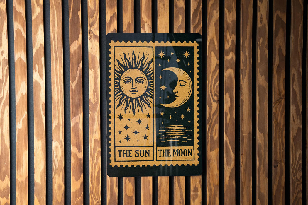 A sign with the sun and moon depicted on it, mounted on a wooden wall.
