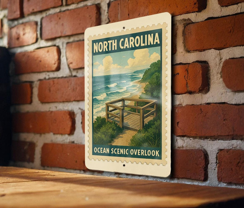 A vintage-style metal sign with the text "NORTH CAROLINA OCEAN SCENIC OVERLOOK" is displayed on a brick wall.