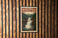 A vintage-style poster of Wisconsin's Waterfall Loop is displayed on a wooden wall.