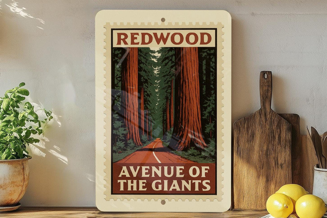 a framed poster of a scenic road leading through a forest of tall trees, with the text "REDWOOD AVENUE OF THE GIANTS" prominently displayed.