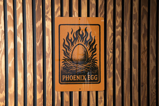 a sign with the text "PHOENIX EGG" and an illustration of a flaming egg nestled in a wreath.