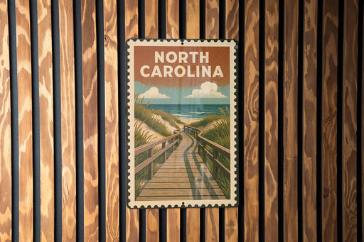 A vintage-style poster of a wooden boardwalk leading to a beach is displayed on a wooden wall.
