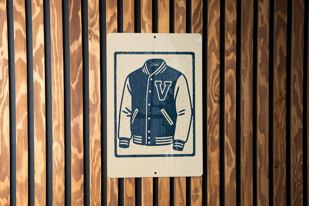 A sign featuring a graphic of a v-shaped jacket is mounted on a wooden wall.