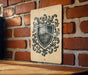 a wooden table with a decorative shield-shaped sign hanging on the wall behind it.