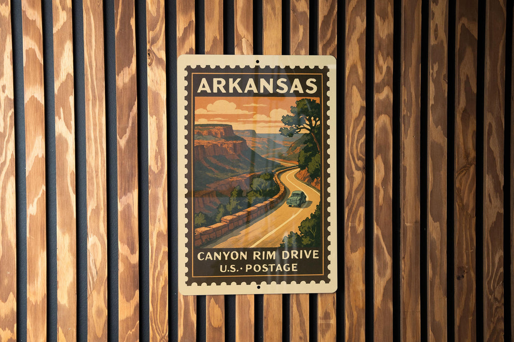 A vintage postage stamp from Arkansas depicting a scenic road leading to a canyon, mounted on a wooden wall.