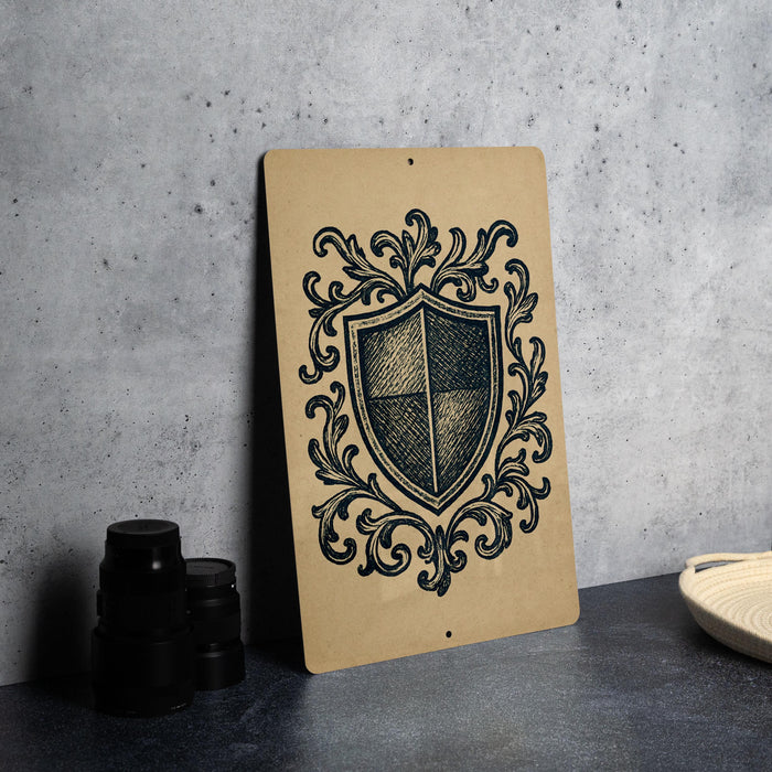 a shield-shaped design with a decorative border, placed on a surface next to some black objects.