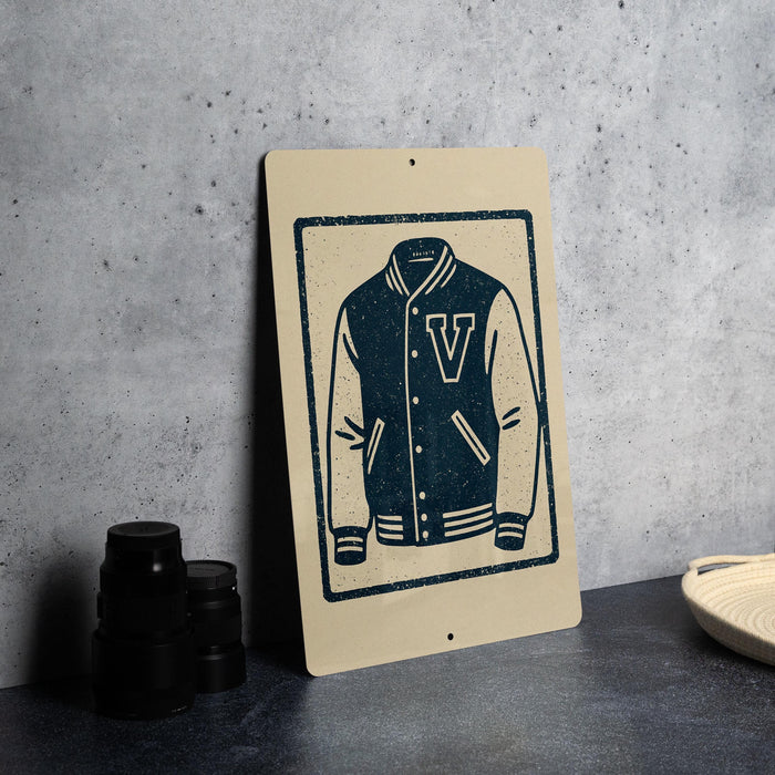 a sign with a graphic of a v-shaped jacket, placed on a table next to some black camera lenses.