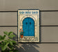 a blue door with a potted plant on the steps, mounted on a wall.