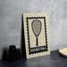 a racquetball sign with a racquet and the word "RACQUETBALL" printed on it, placed on a table next to some black camera lenses.