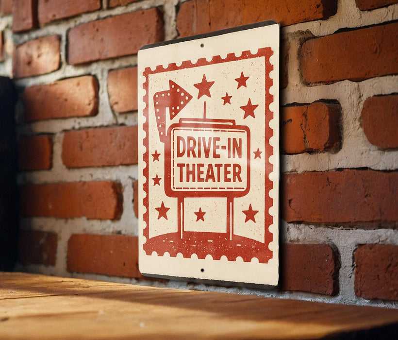 A sign on a brick wall that reads "DRIVE-IN THEATER" with stars and a rocket ship design.
