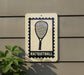 A sign with a racquetball symbol on it is mounted on a wall, with a plant visible to the left.