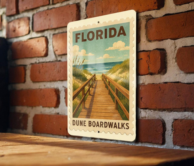 A vintage-style sign for Florida Dune Boardwalks is displayed on a brick wall, featuring a wooden walkway leading to the beach.