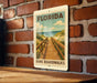 A vintage-style sign for Florida Dune Boardwalks is displayed on a brick wall, featuring a wooden walkway leading to the beach.
