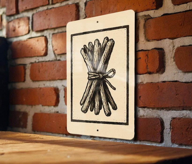 a sign with a black and white illustration of a bundle of sticks or branches, which is mounted on a brick wall.
