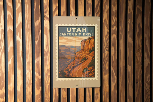 A vintage-style sign for Utah Canyon Rim Drive, featuring a scenic illustration of a winding road leading to a mountainous landscape.