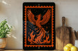 a black and orange sign with a phoenix design, surrounded by various kitchen items such as a wooden cutting board, a potted plant, and a bowl of lemons.